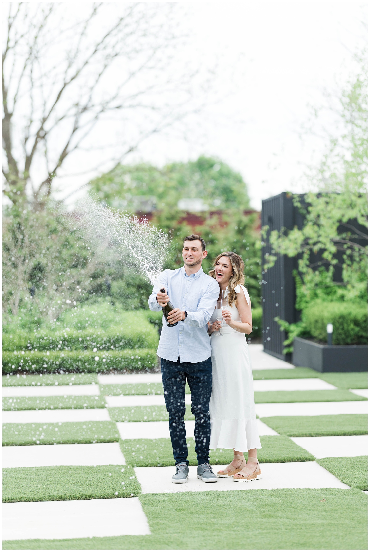 popping champagne at engagement session