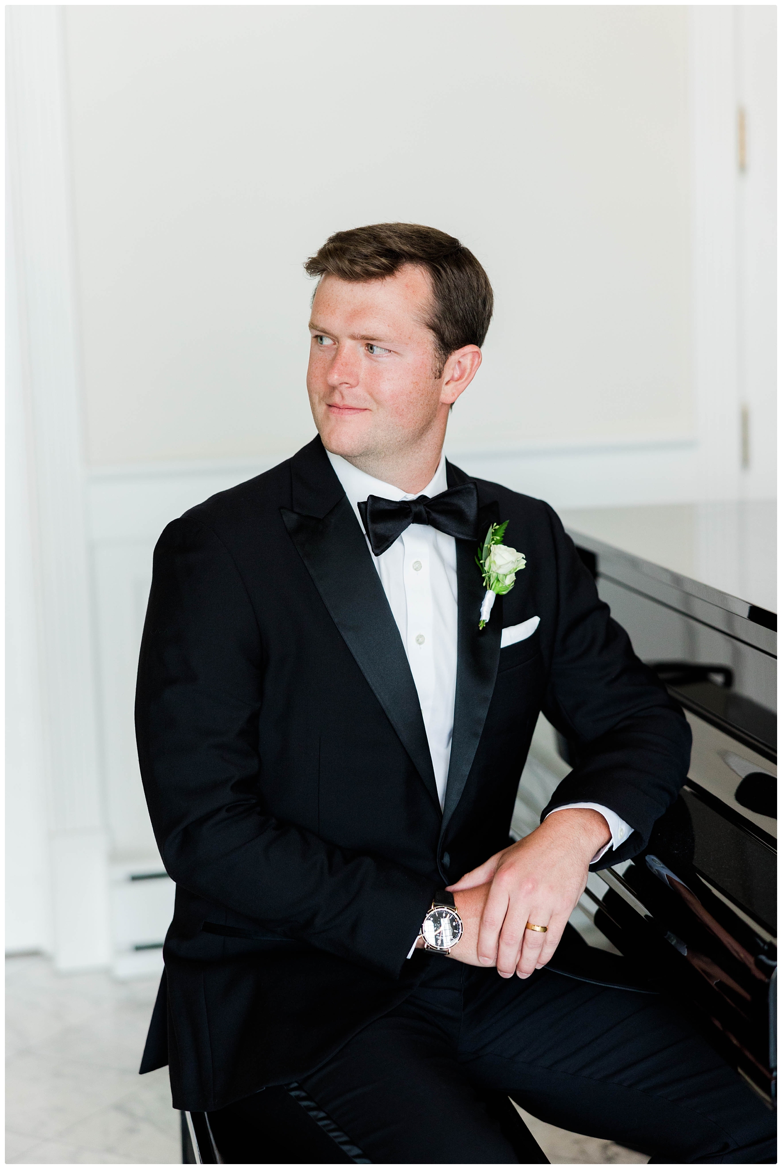 groom portrait sitting at piano