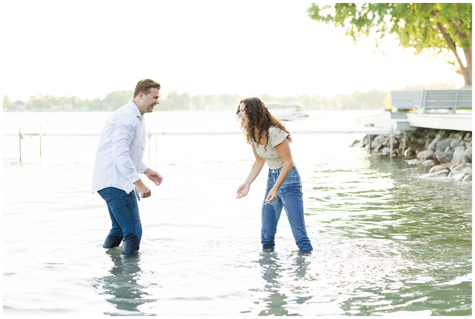 engagement photos splashing in the lake