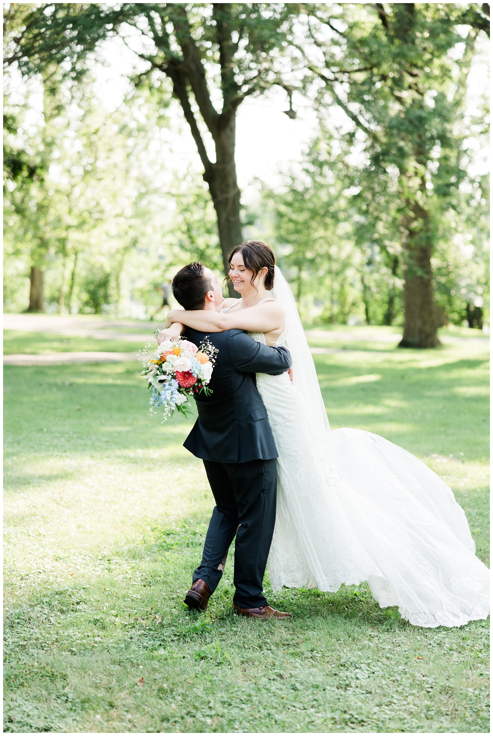 groom lifting bride photo