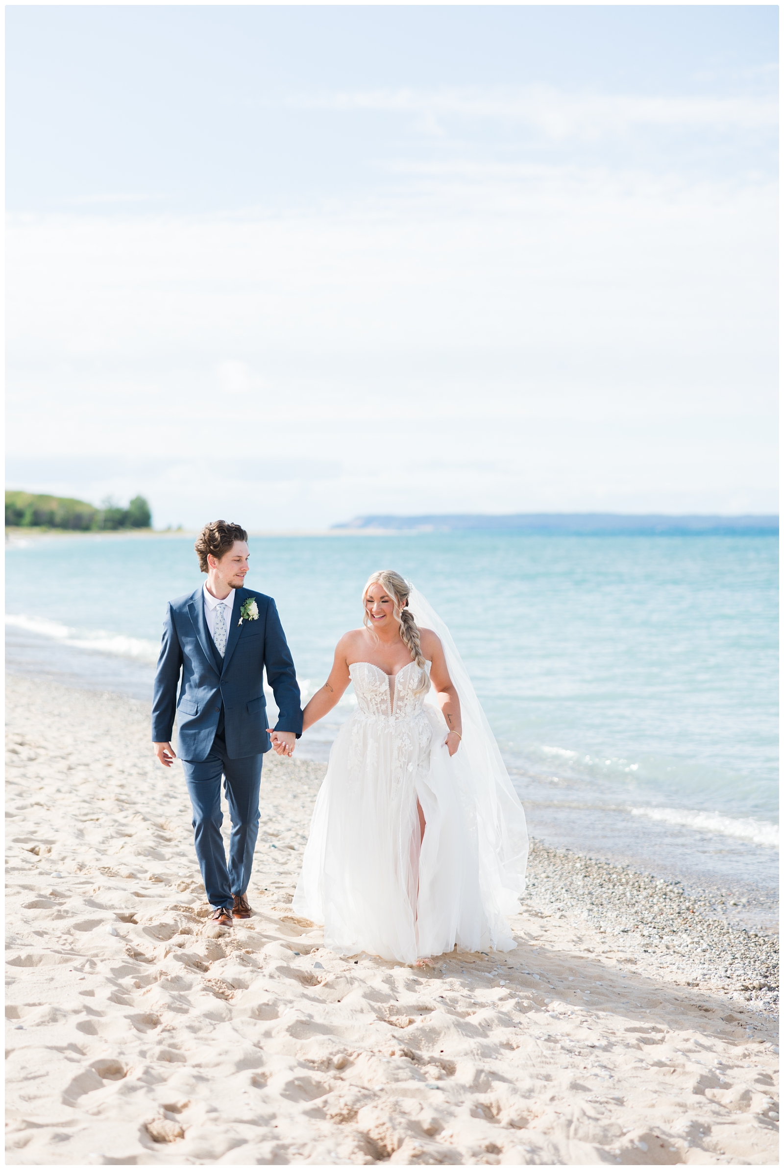 lake michigan elopement wedding photo of bride and groom walking hand in hand