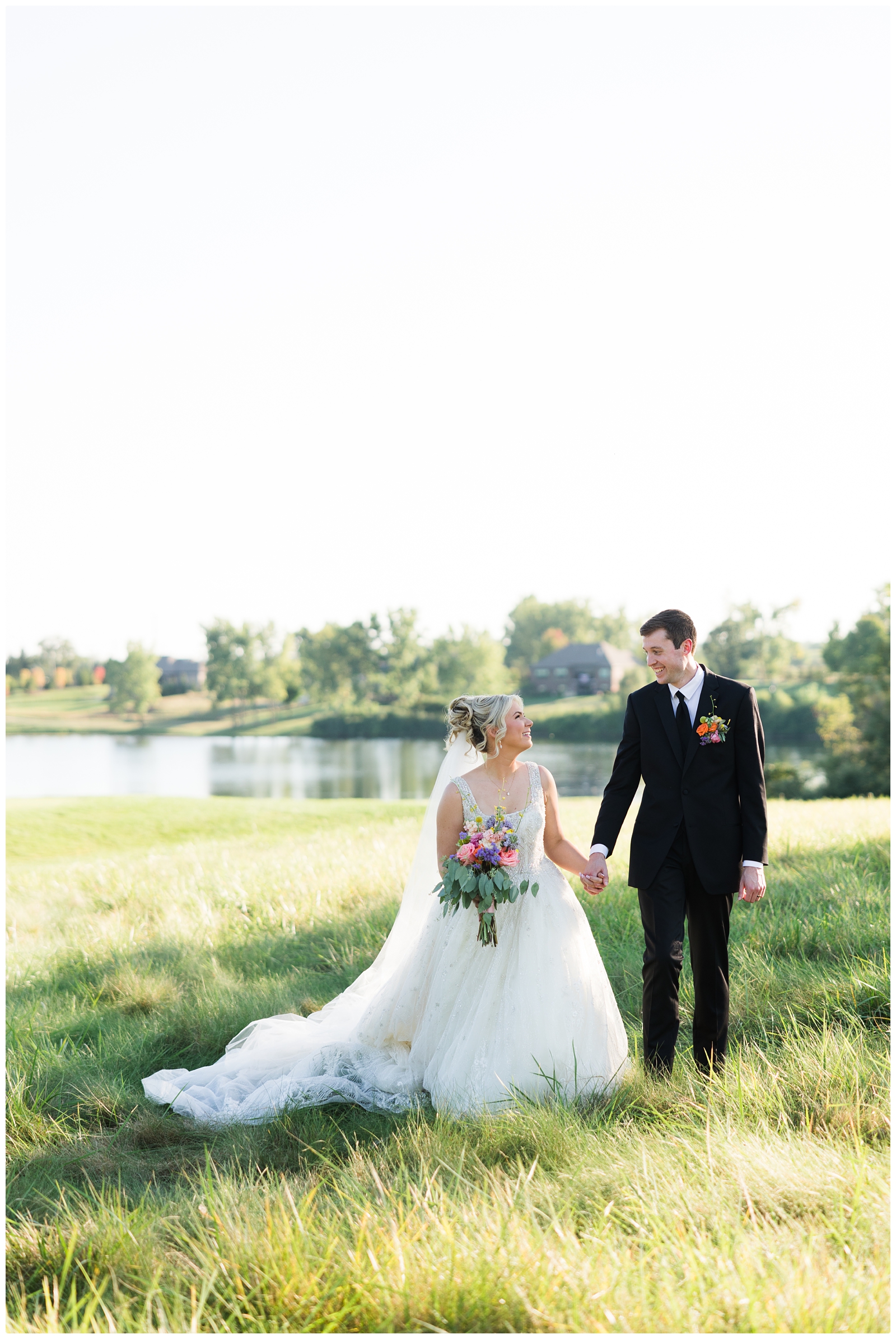 bride and groom holding hands at their Greystone Golf Club & Banquet Center wedding