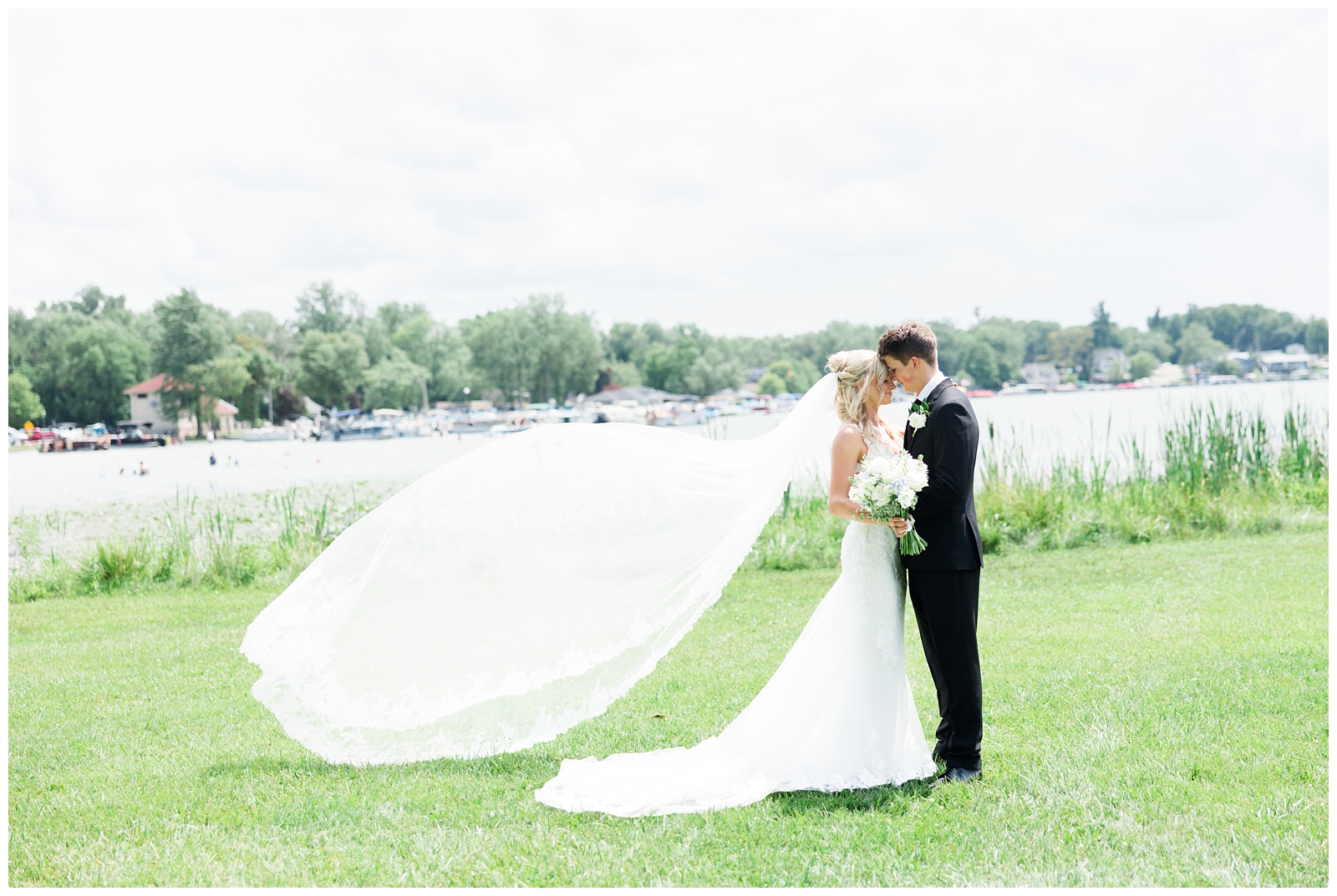 White Birch Wedding Barn wedding photo of bride and groom with veil blowing in the wind