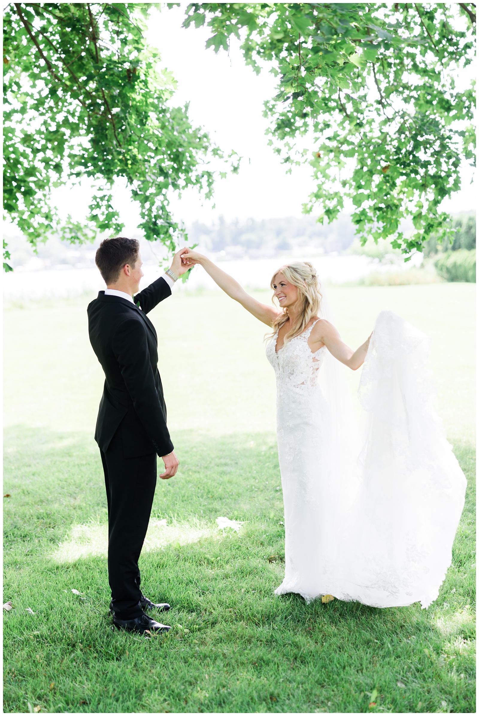 groom twirling his bride at their White Birch Wedding Barn wedding