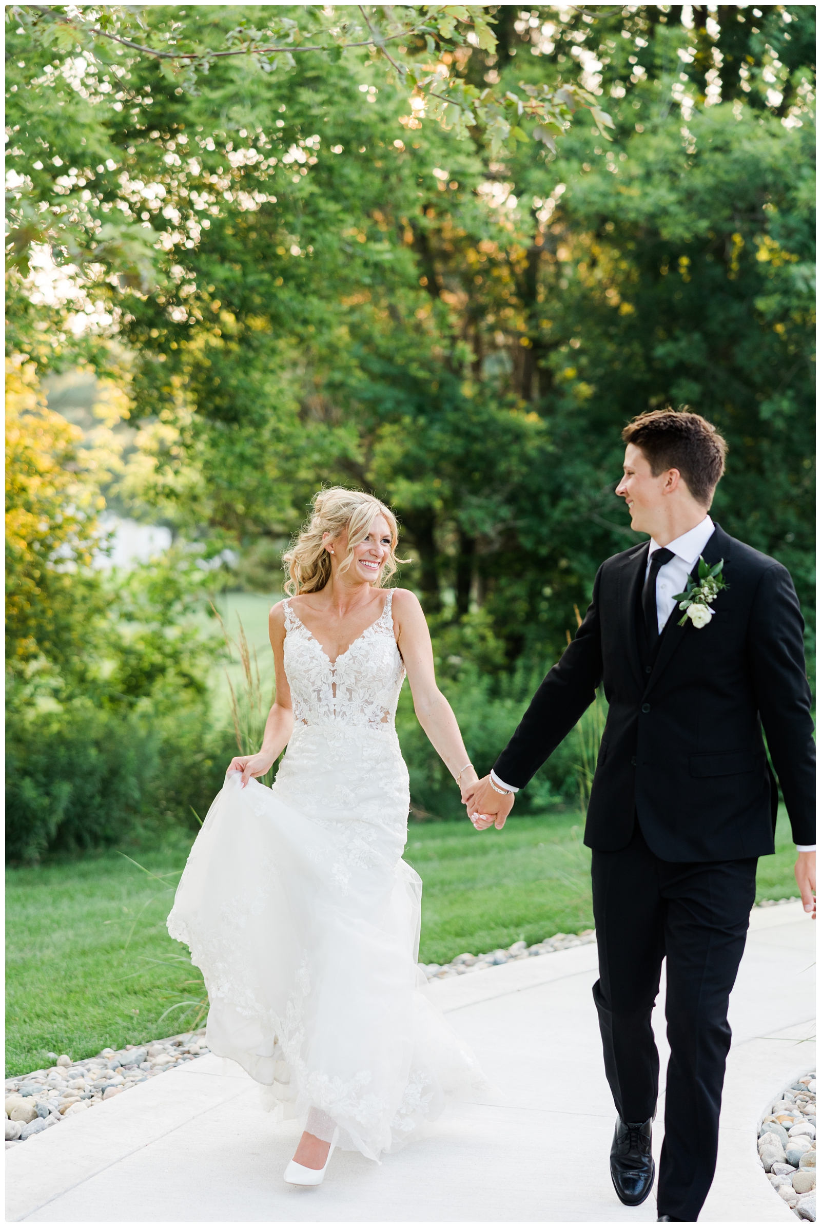 bride and groom wedding photo walking hand in hand at White Birch Wedding Barn
